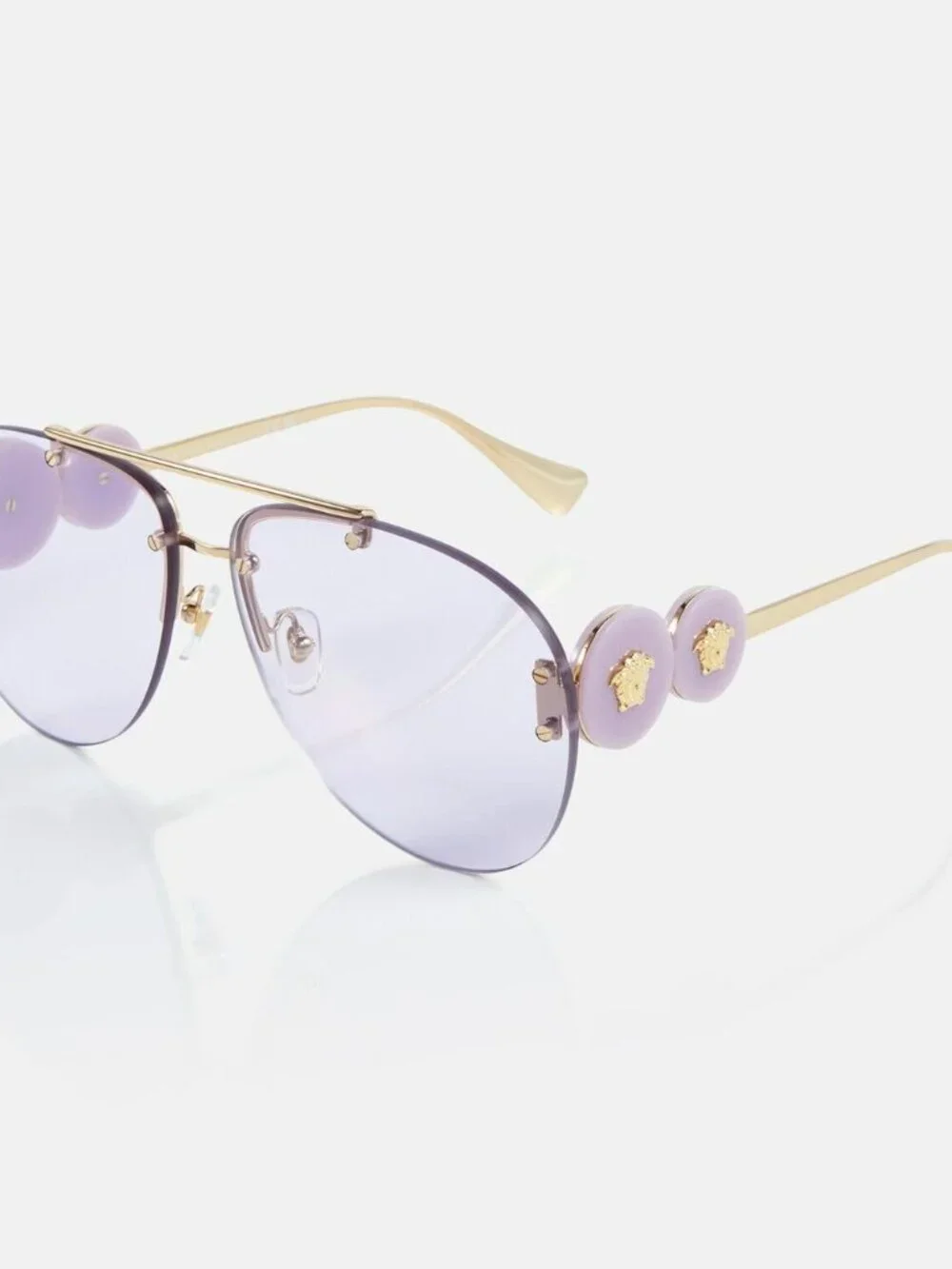 Versace rimless aviator sunglasses with a gold-tone frame and light purp